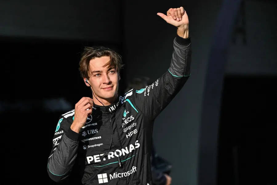 Mercedes' British driver George Russell celebrates after getting pole position in the sprint qualifying session