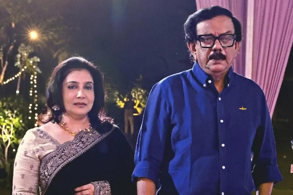 Director Priyadarshan and actress Lissy posing together at a social gathering