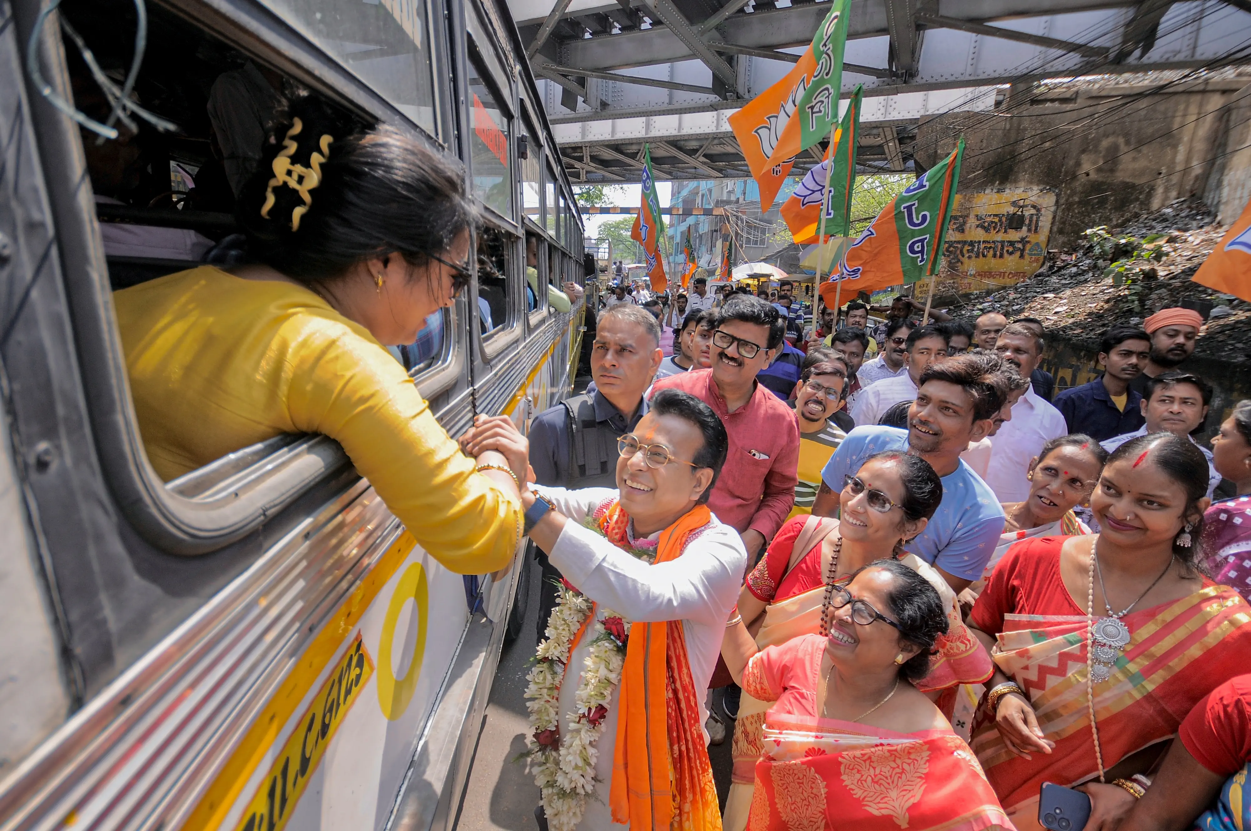 BJP candidate Rudranil Ghosh interacts with a woman during a door-to-door campaign, in Howrah | Photo: PTI