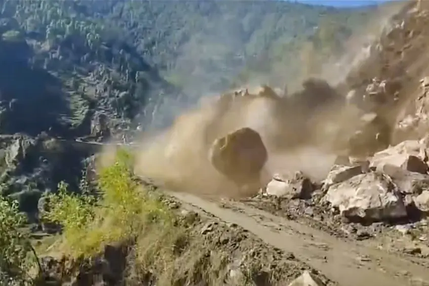 A boulder rolls down following a landslide triggered by heavy rains near Ropru village in Mandi district