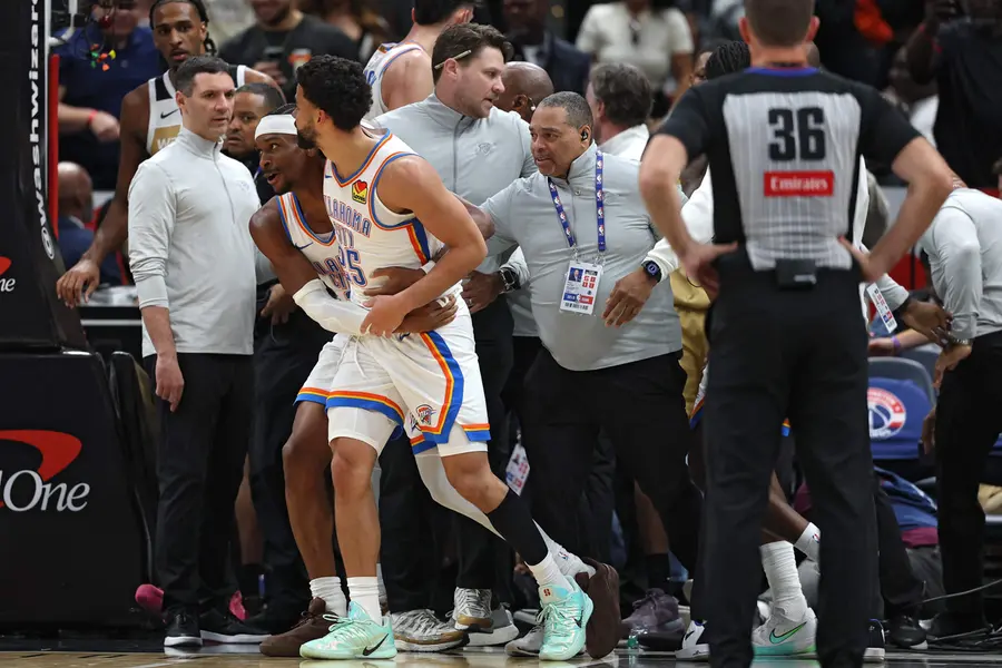 Ajay Mitchell pulled out of a scrum of players by teammate Shai Gilgeous-Alexander against the Washington Wizards