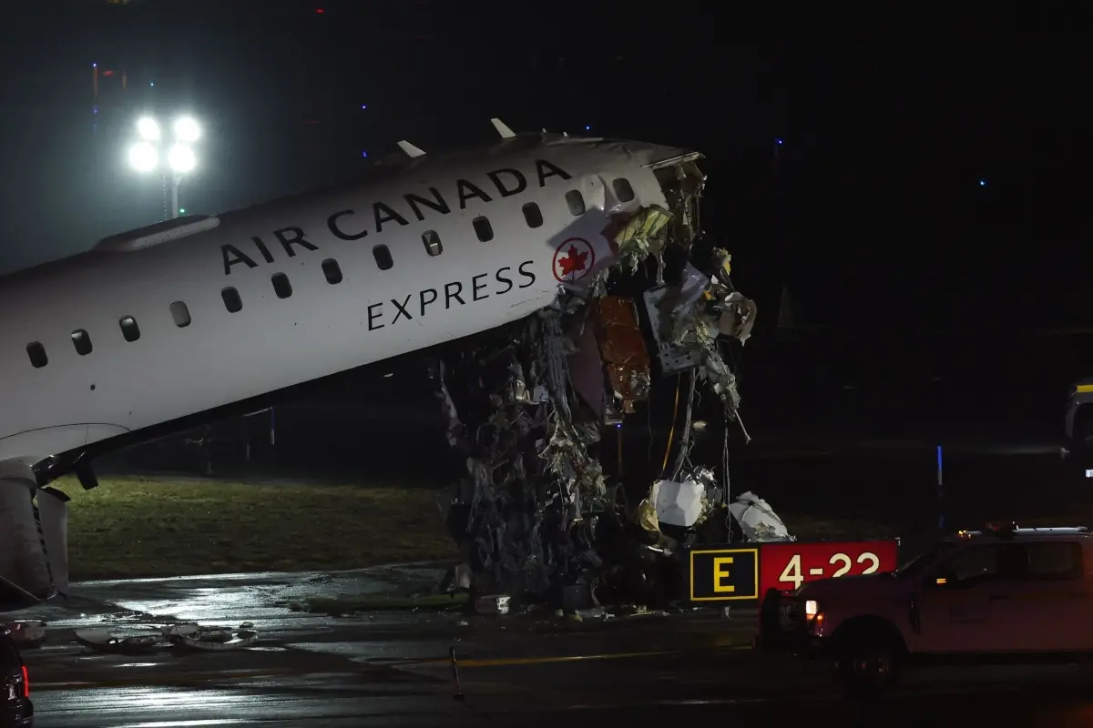 An Air Canada Express CRJ-900 sits on the runway after colliding with a Port Authority fire truck at LaGuardia Airport in New York