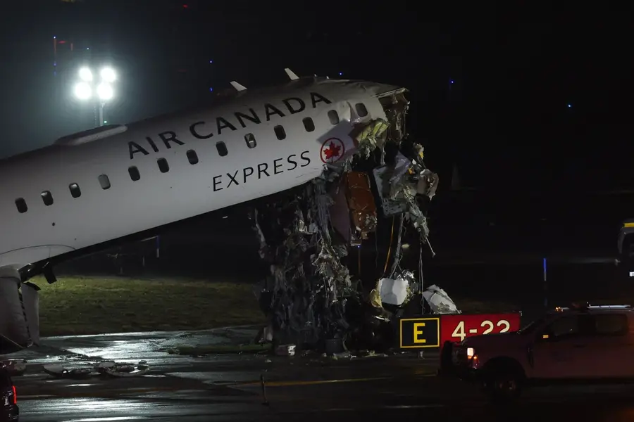 An Air Canada Express CRJ-900 sits on the runway after colliding with a Port Authority fire truck at LaGuardia Airport in New York