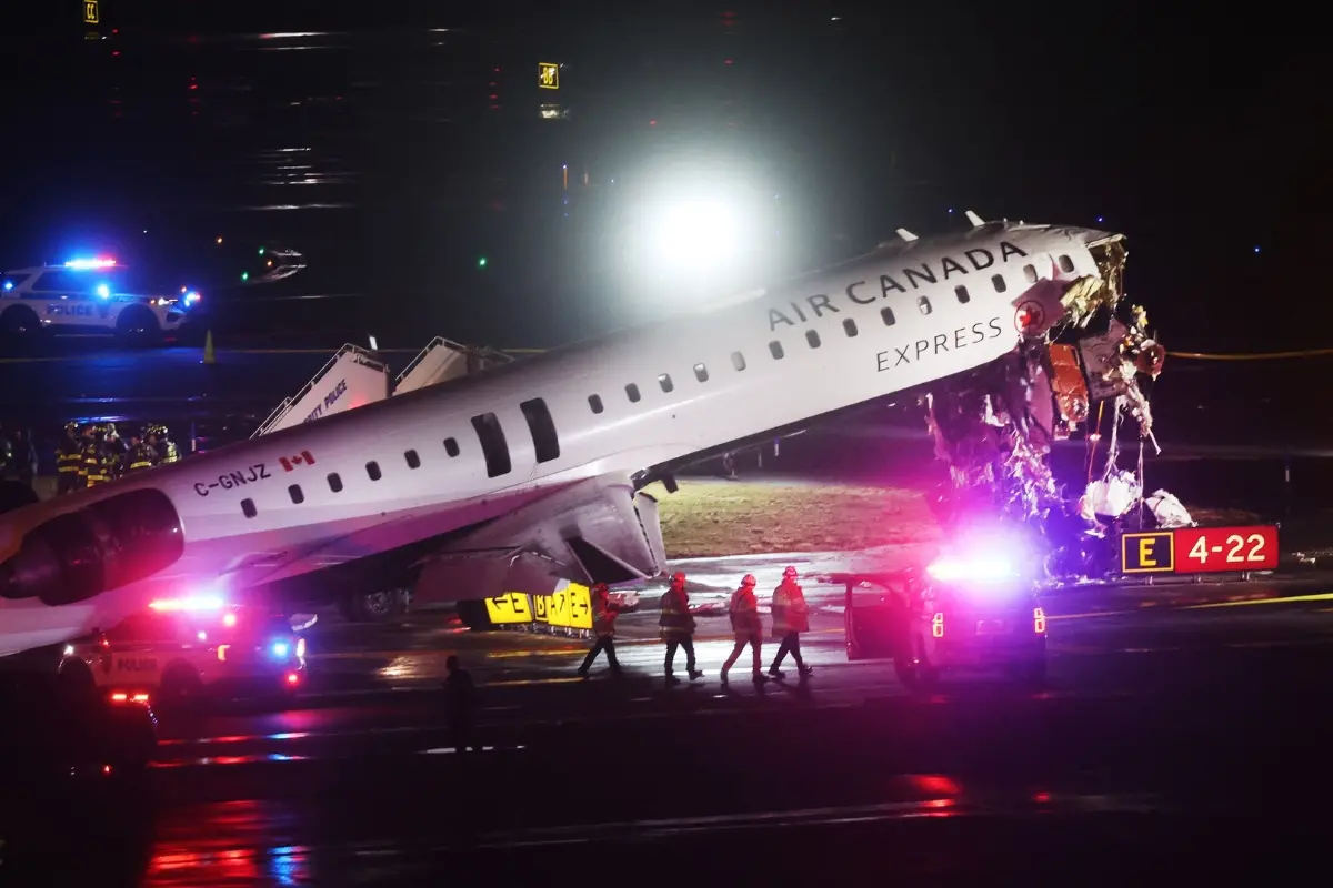 An Air Canada Express plane sits on the tarmac after it collided with a fire truck on the tarmac at LaGuardia Airport.| Photo: AFP