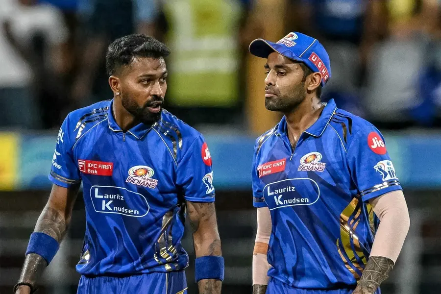 Mumbai Indians' Suryakumar Yadav (R) speaks with captain Hardik Pandya during the Indian Premier League (IPL)