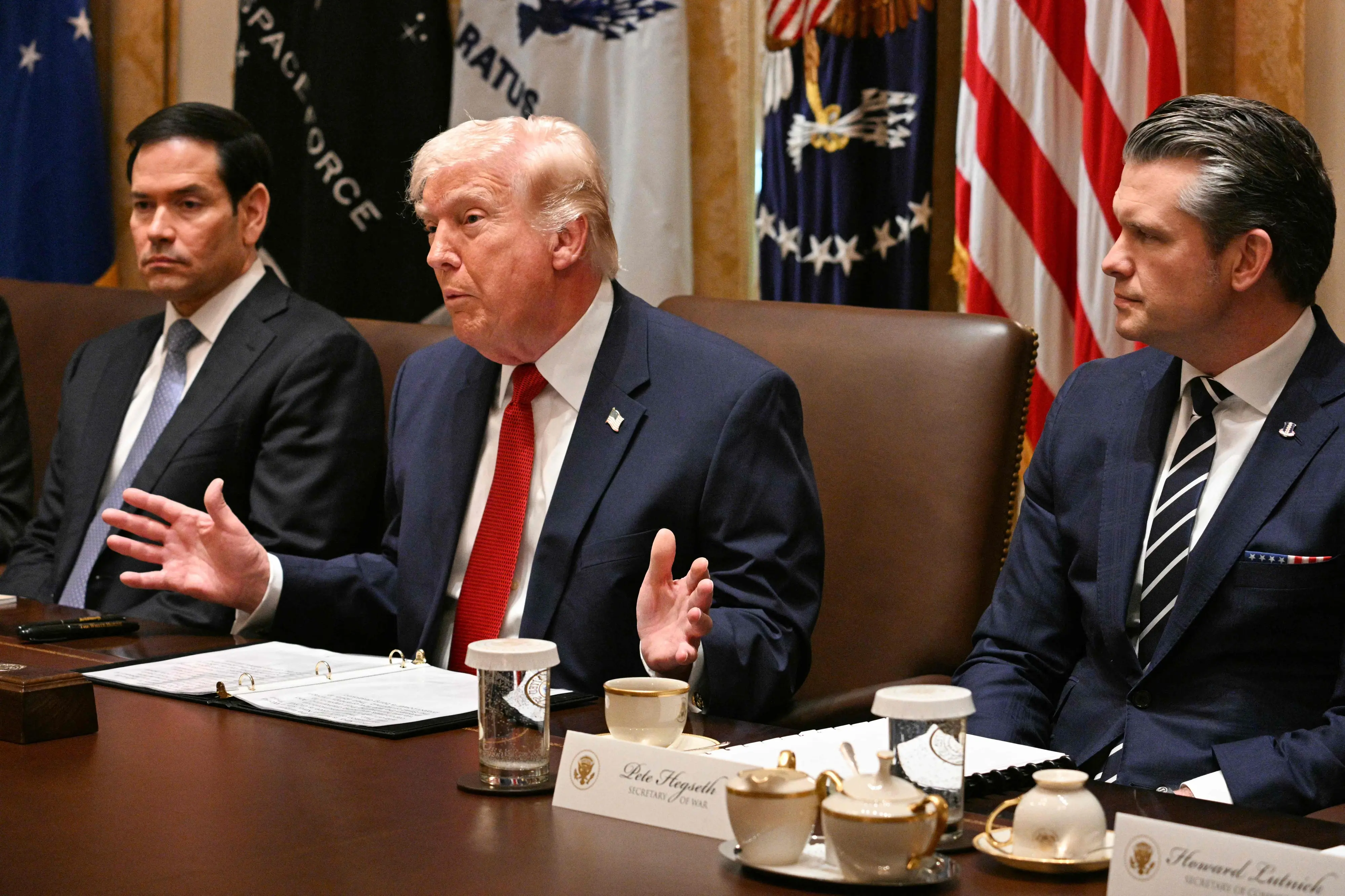 US President Donald Trump, flanked by Secretary of State Marco Rubio (L) and Defense Secretary Pete Hegseth (R), speaks during a cabinet meeting in the Cabinet Room of the White House in Washington | AFP