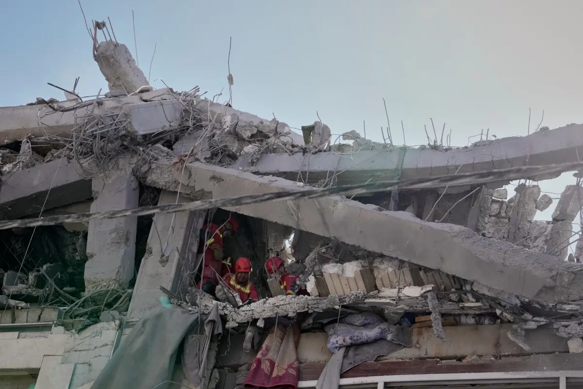 First responders inspect a residential building hit in US-Israeli strike in Tehran | Photo: AP