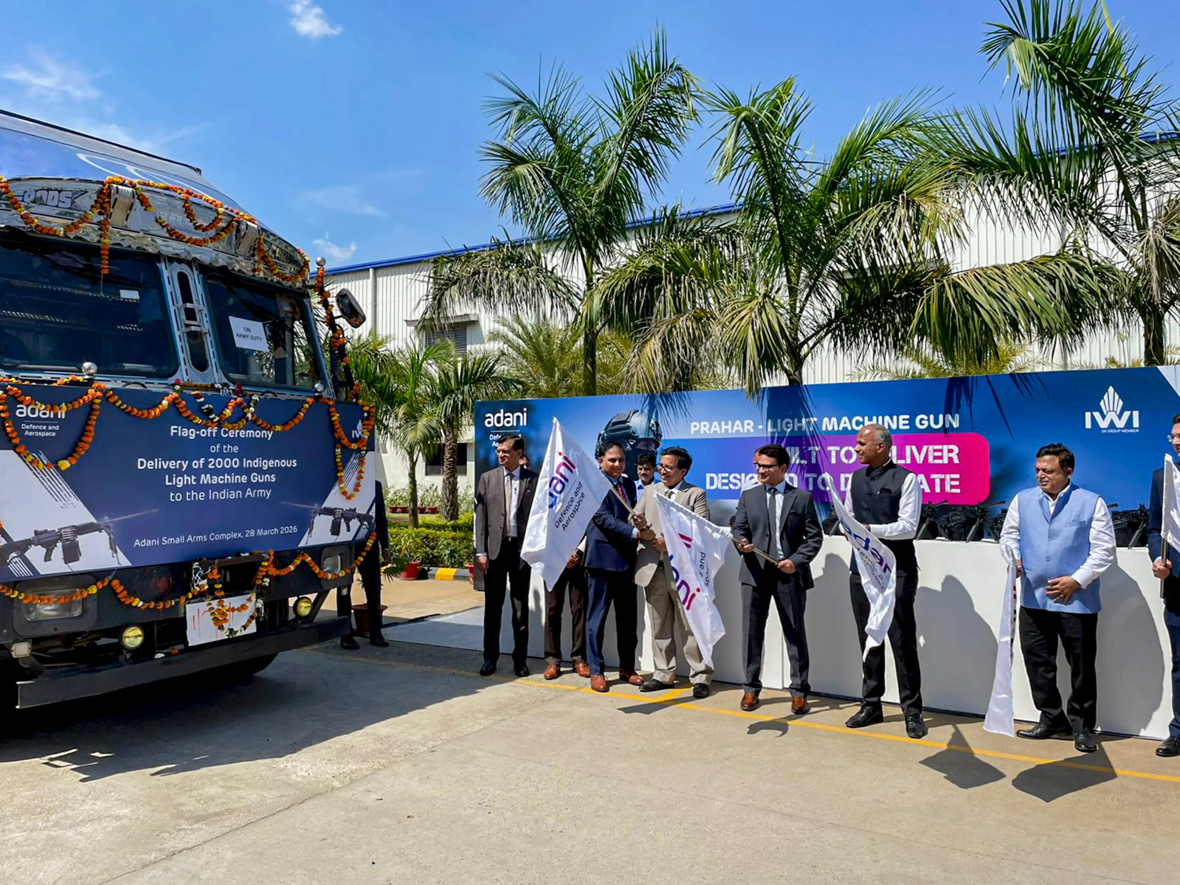 A Anbarasu, DG Acquisition, Ministry of Defence, Ashish Rajvanshi, CEO of Adani Defence and Aerospace, and other senior officials flag off trucks carrying 'Prahar' light machine guns (LMGs) | PTI