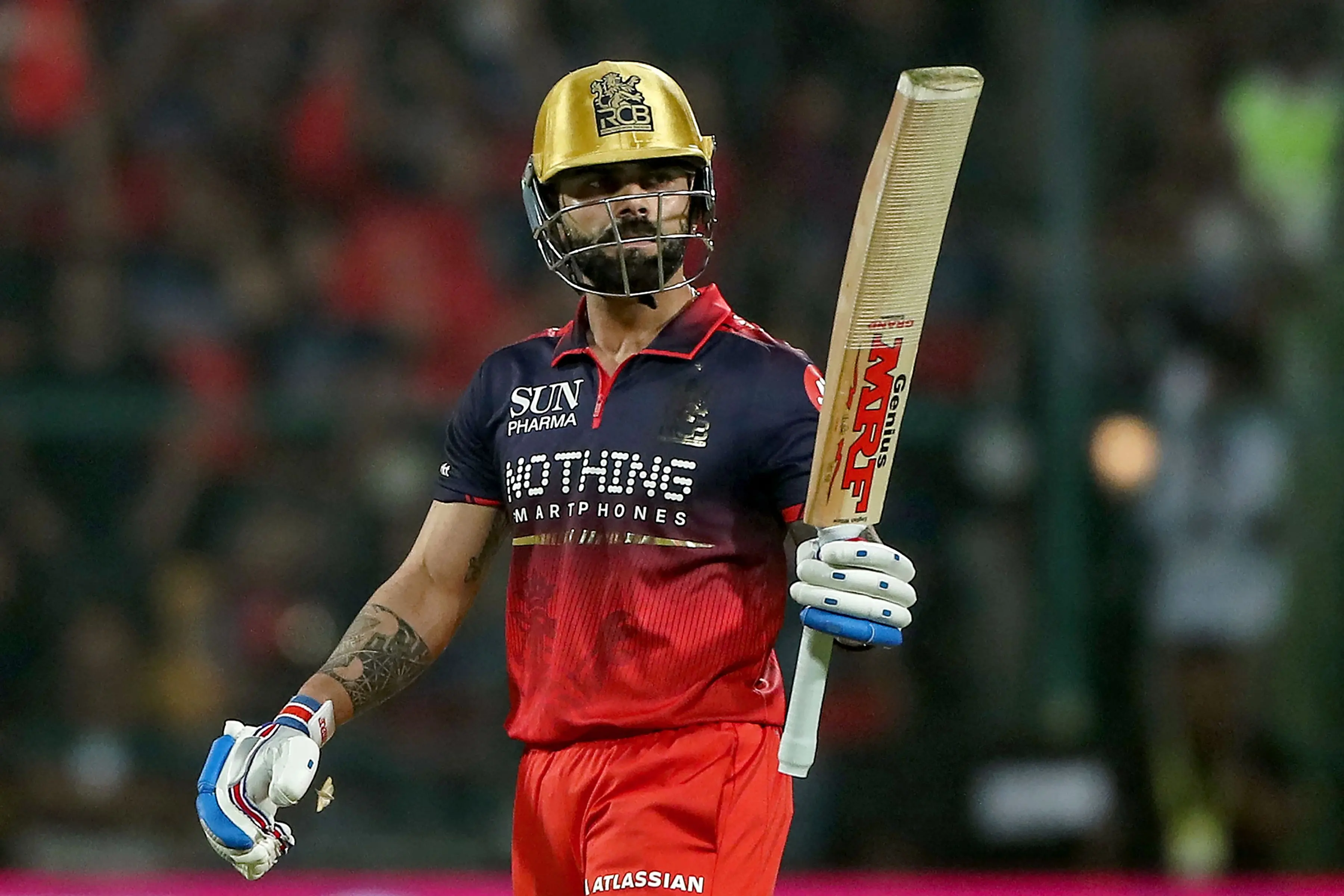 Royal Challengers Bengaluru's Indian cricket player Virat Kohli celebrates after scoring a half-century | AFP