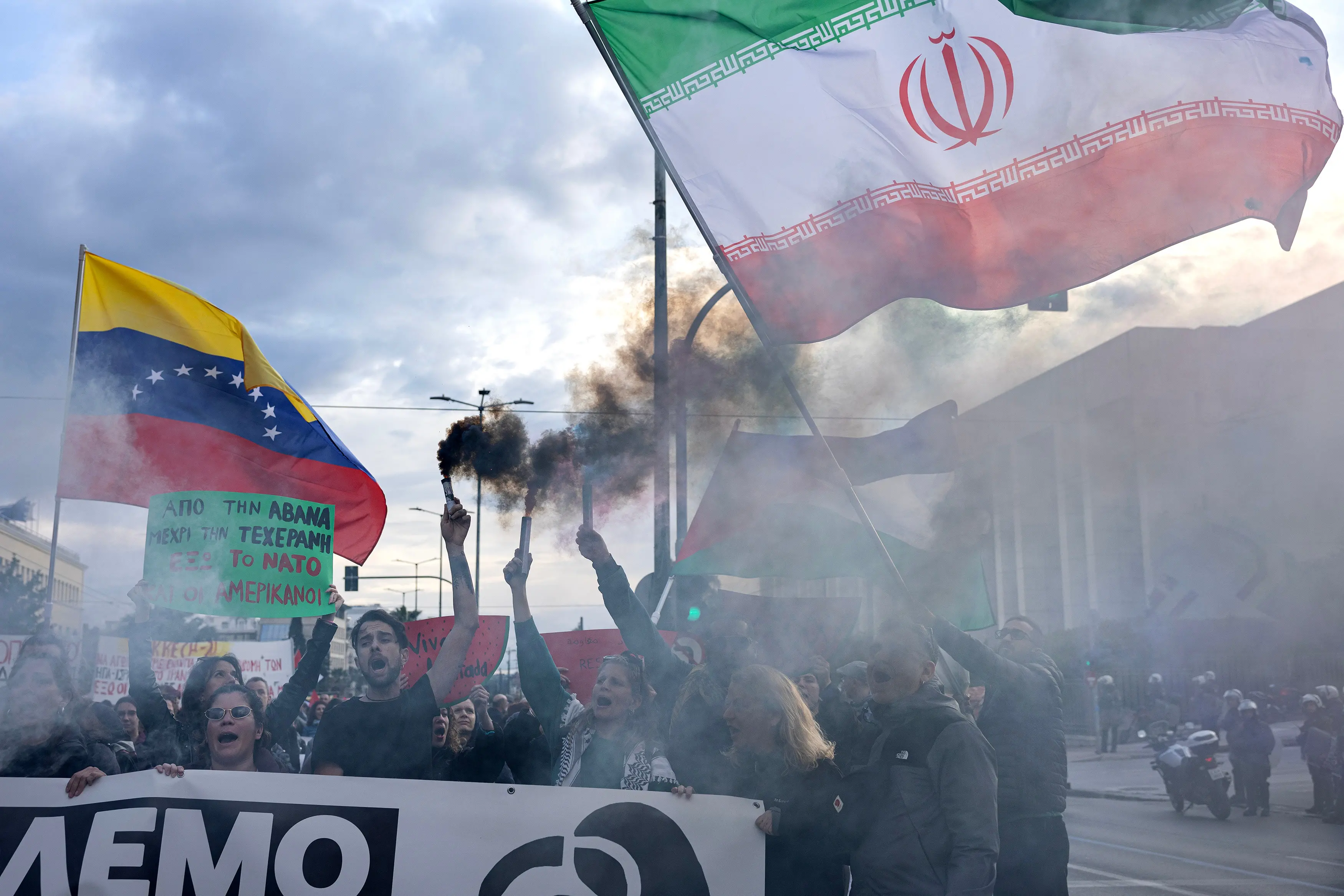 Protesters hold flares as they take part in a protest against the Israel war against Iran and Hezbollah | AP