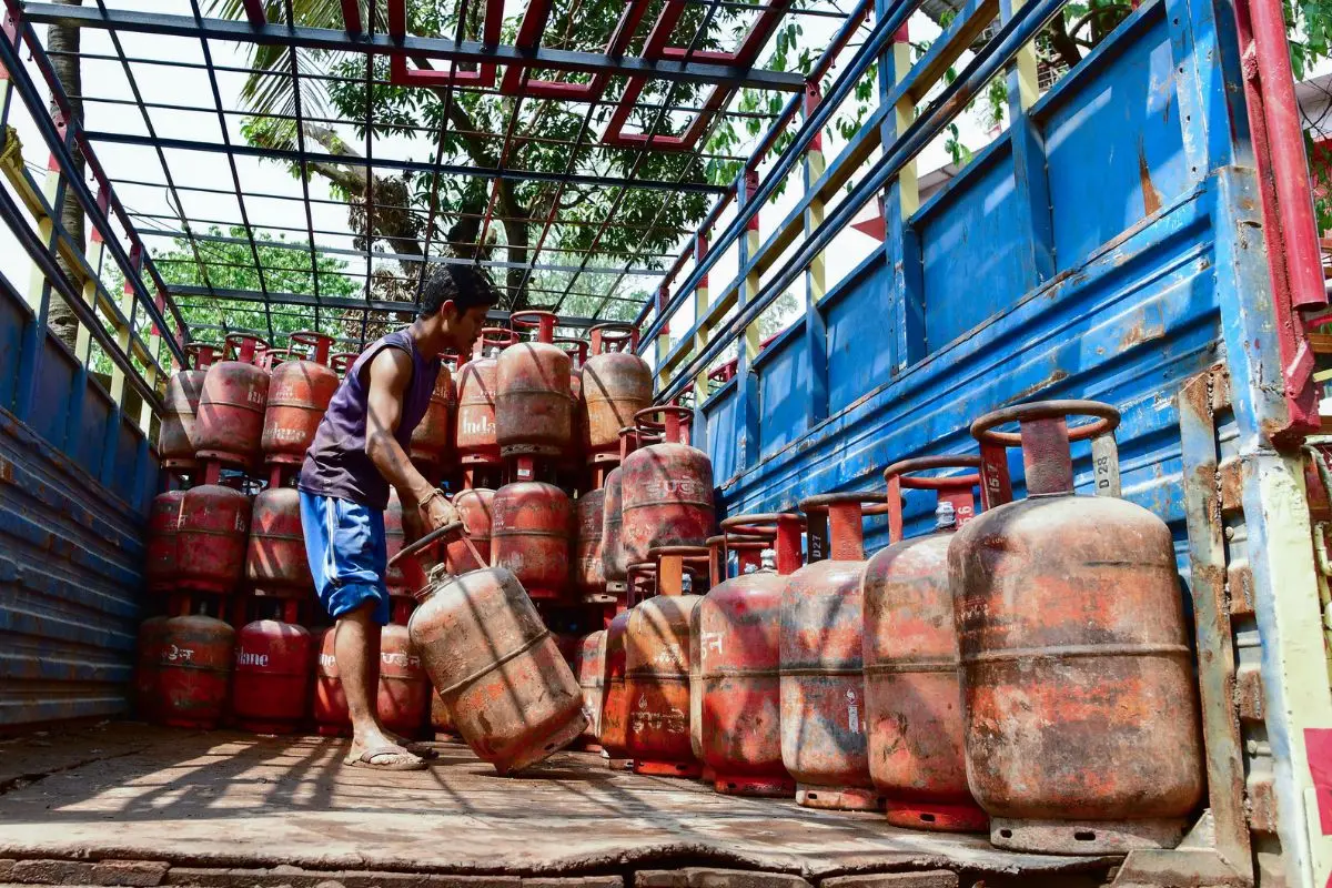 A worker unload the gas cylinders from a truck at a LPG distribution center (Photo: ANI)