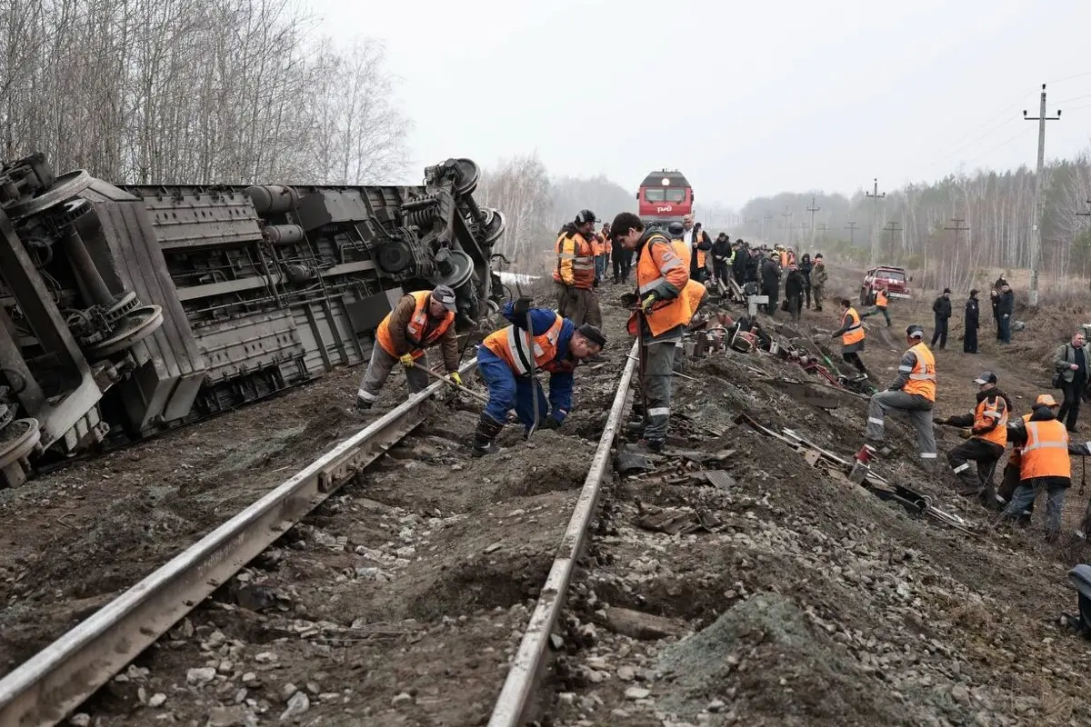 Railway employees work at the passenger train derailment site near Bryandino village, Ulyanovsk region, Russia.