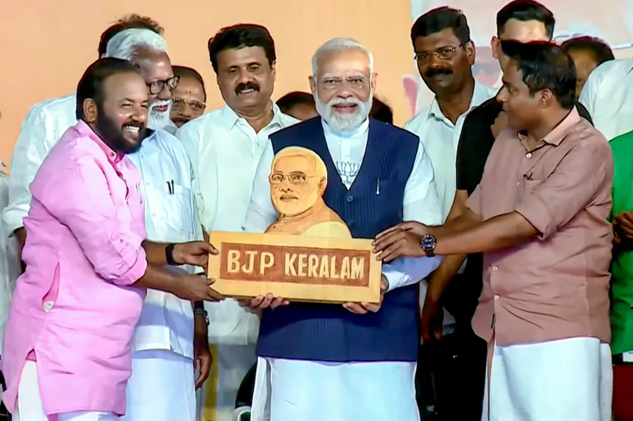 Prime Minister Narendra Modi, centre, being felicitated during a public meeting ahead of the Kerala Assembly elections, in Thiruvalla