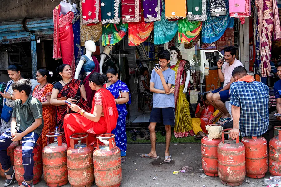 People wait in a queue to refill LPG cylinders amid disruptions due to the ongoing West Asia war, in Mumbai