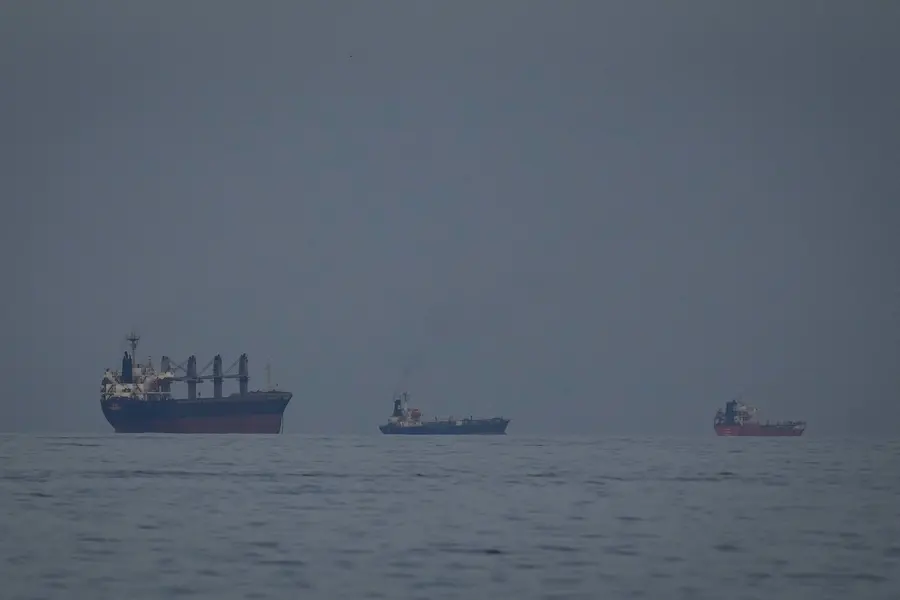 Oil tankers and ships line up in the Strait of Hormuz as seen from Khor Fakkan, United Arab Emirates, Wednesday