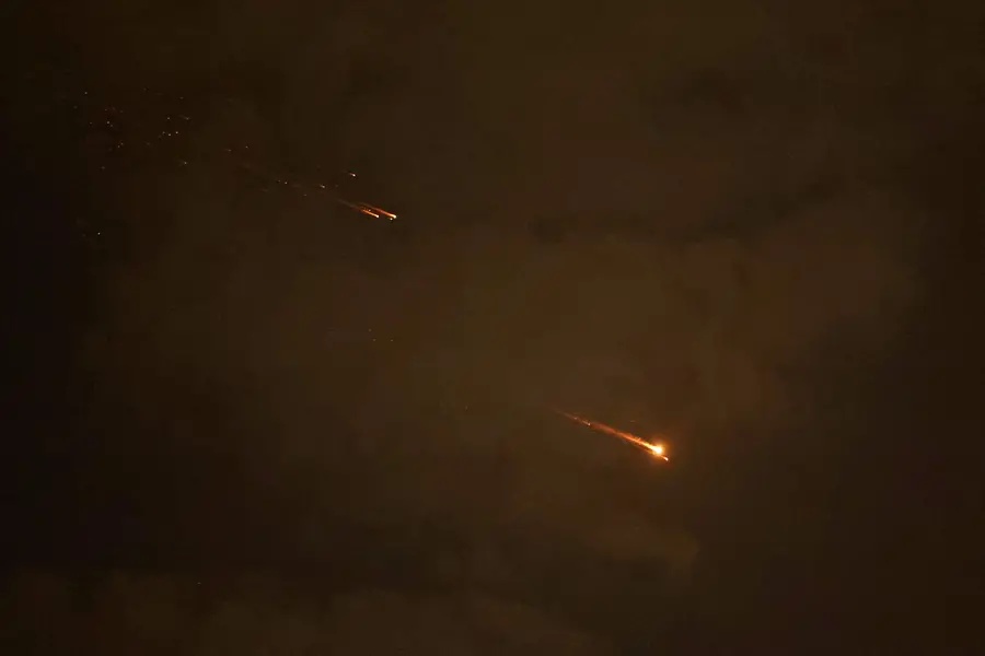 Rocket trails are seen in the sky above the Israeli coastal city of Netanya amid a fresh barrage of Iranian missile attacks