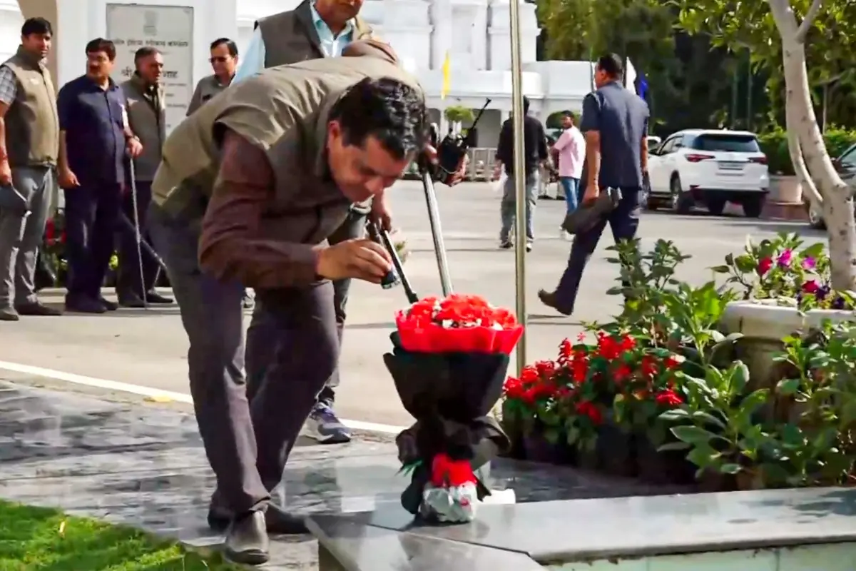 A security official inspects a flower bouquet | Photo: PTI