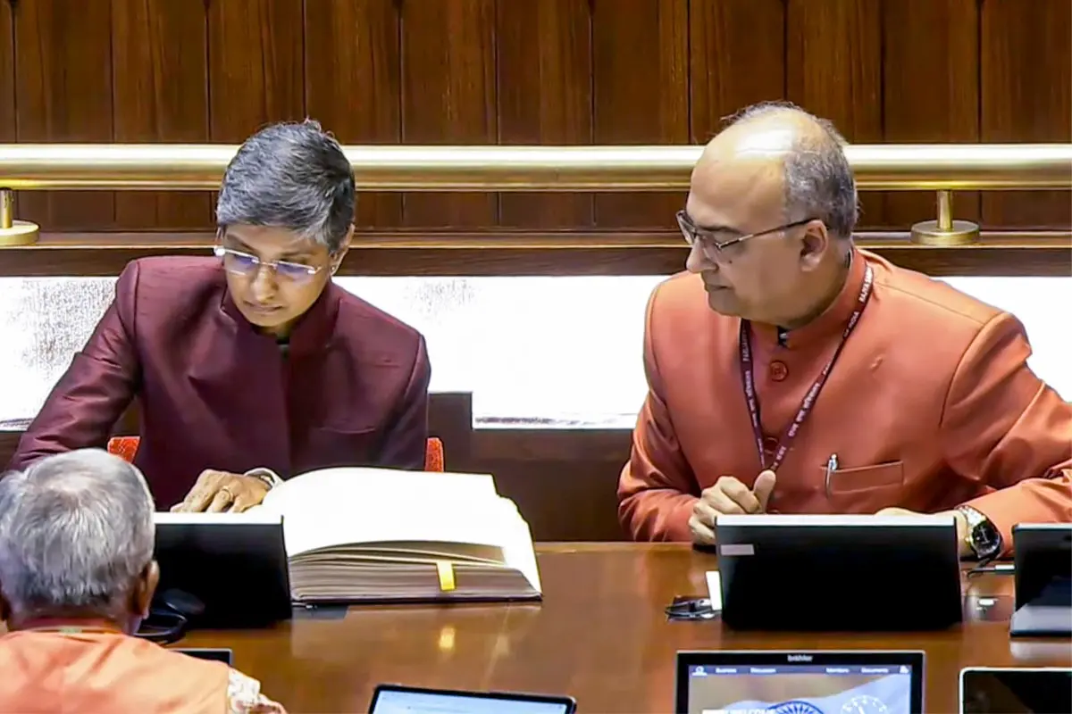 Menaka Guruswamy signs an official document after taking oath as Rajya Sabha MP | Screengrab