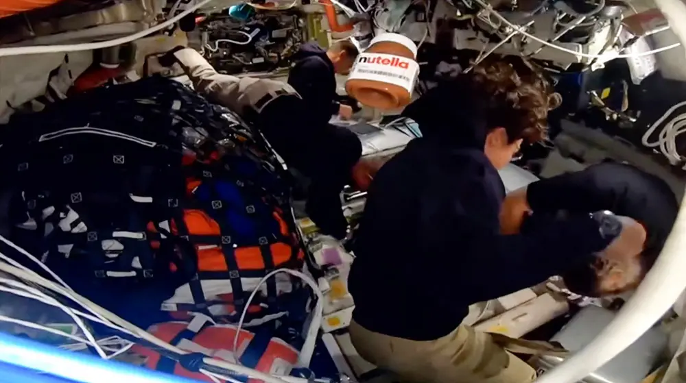 This screengrab from a NASA livestream shows a jar of Nutella floating aboard the Orion spacecraft as Artemis II crew members Victor Glover, Reid Wiseman, Jeremy Hansen and Christina Koch work on April 6, 2026