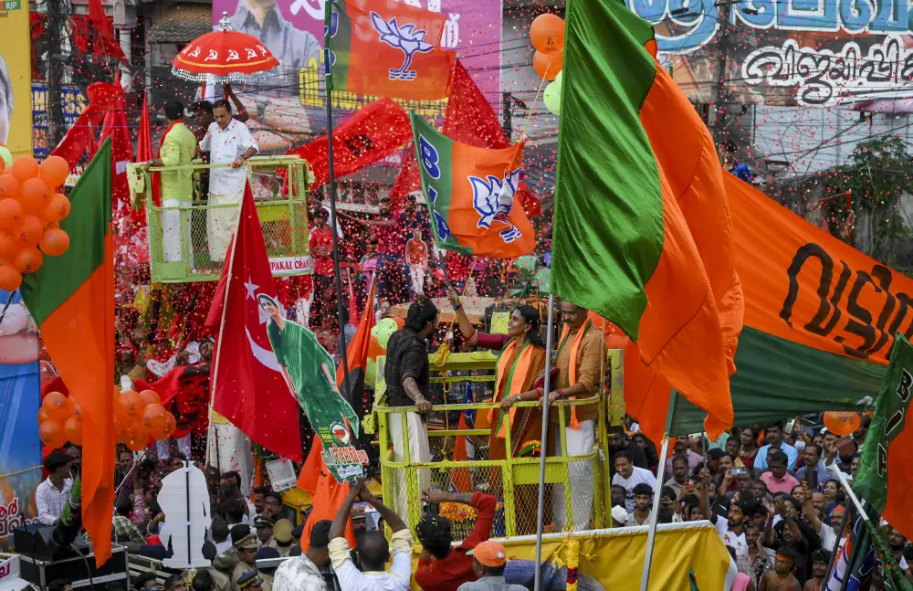 BJP and LDF supporters gather on the final day of open campaigning for the Kerala Assembly elections, at Peroorkada, in Thiruvananthapuram | PTI