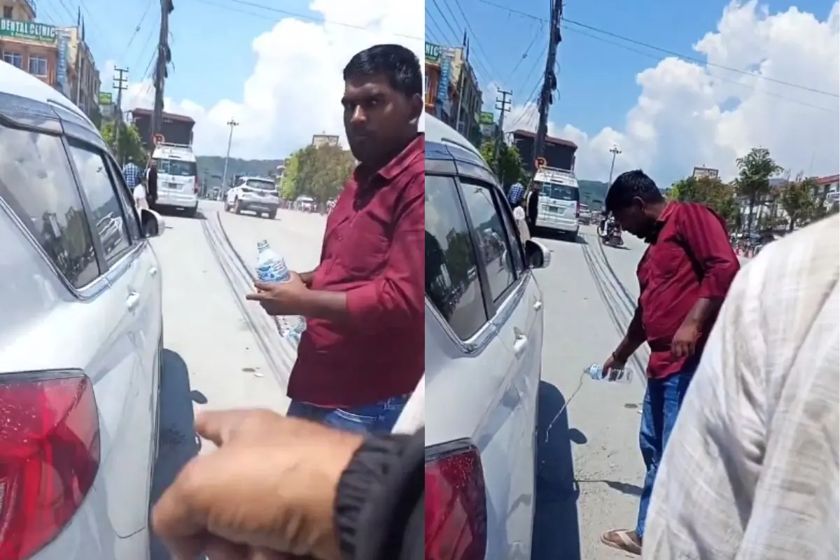 A Nepali man makes tourists clean gutka stains