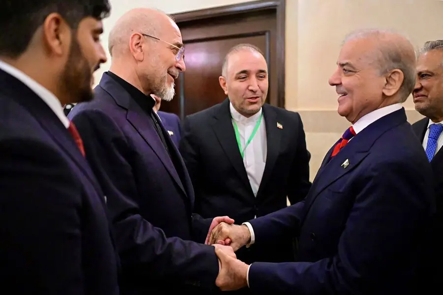 Pakistan's Prime Minister Shehbaz Sharif (2R) with Foreign Minister Ishaq Dar (R) greeting Iran's parliamentary speaker Mohammad Bagher Ghalibaf (2L) during their meeting prior to the US-Iran peace talks in Islamabad