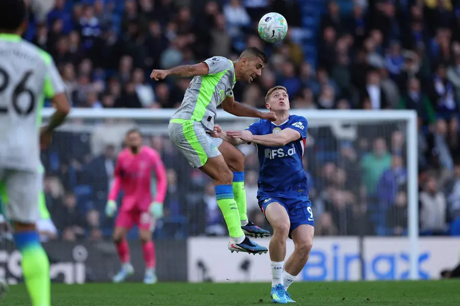 Manchester City's Rodri (L) jumps with Chelsea's Liam Delap