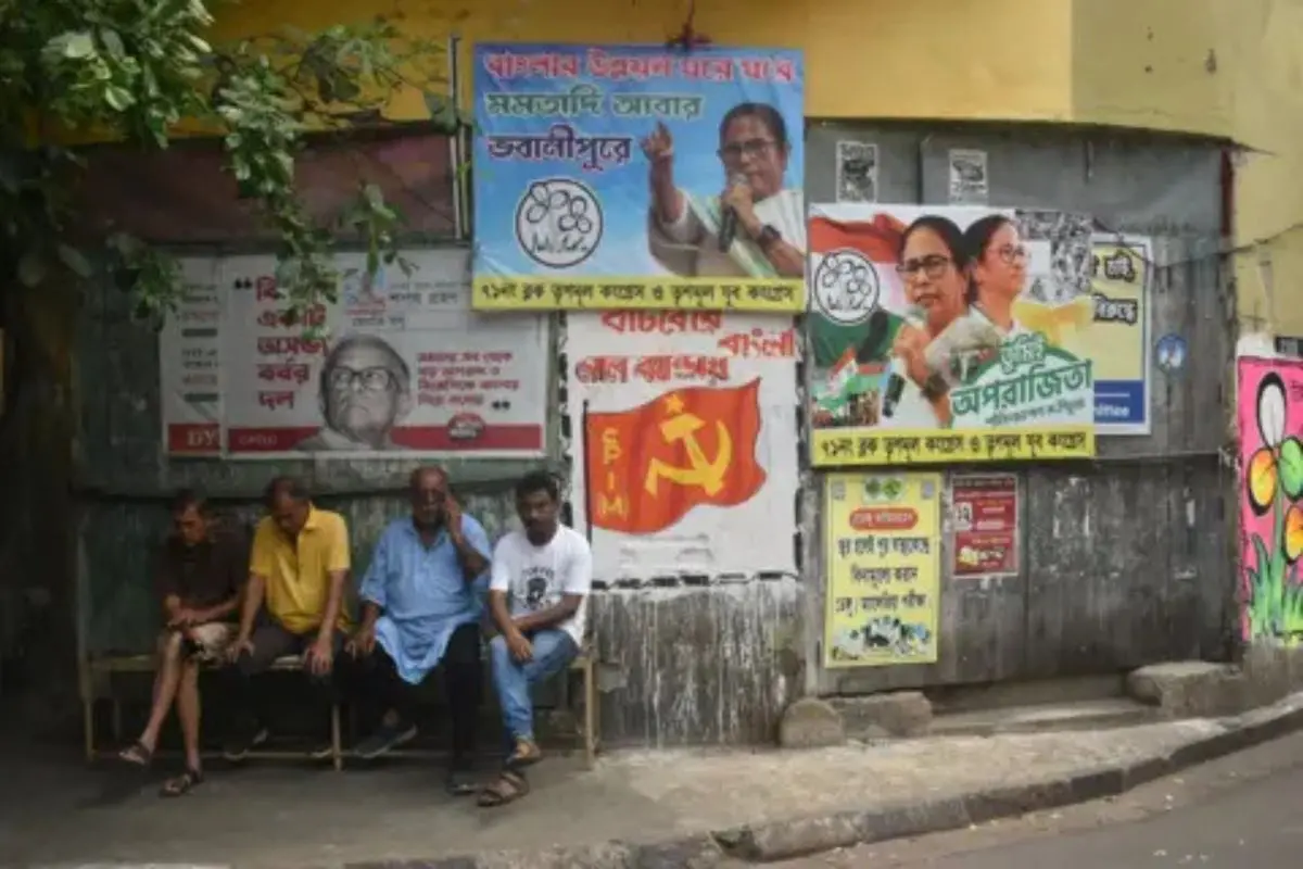 Election posters crowd a Kolkata street wall ahead of phase 2 polling, reflecting the intensifying battle for votes in West Bengal. (Representative photo: X)