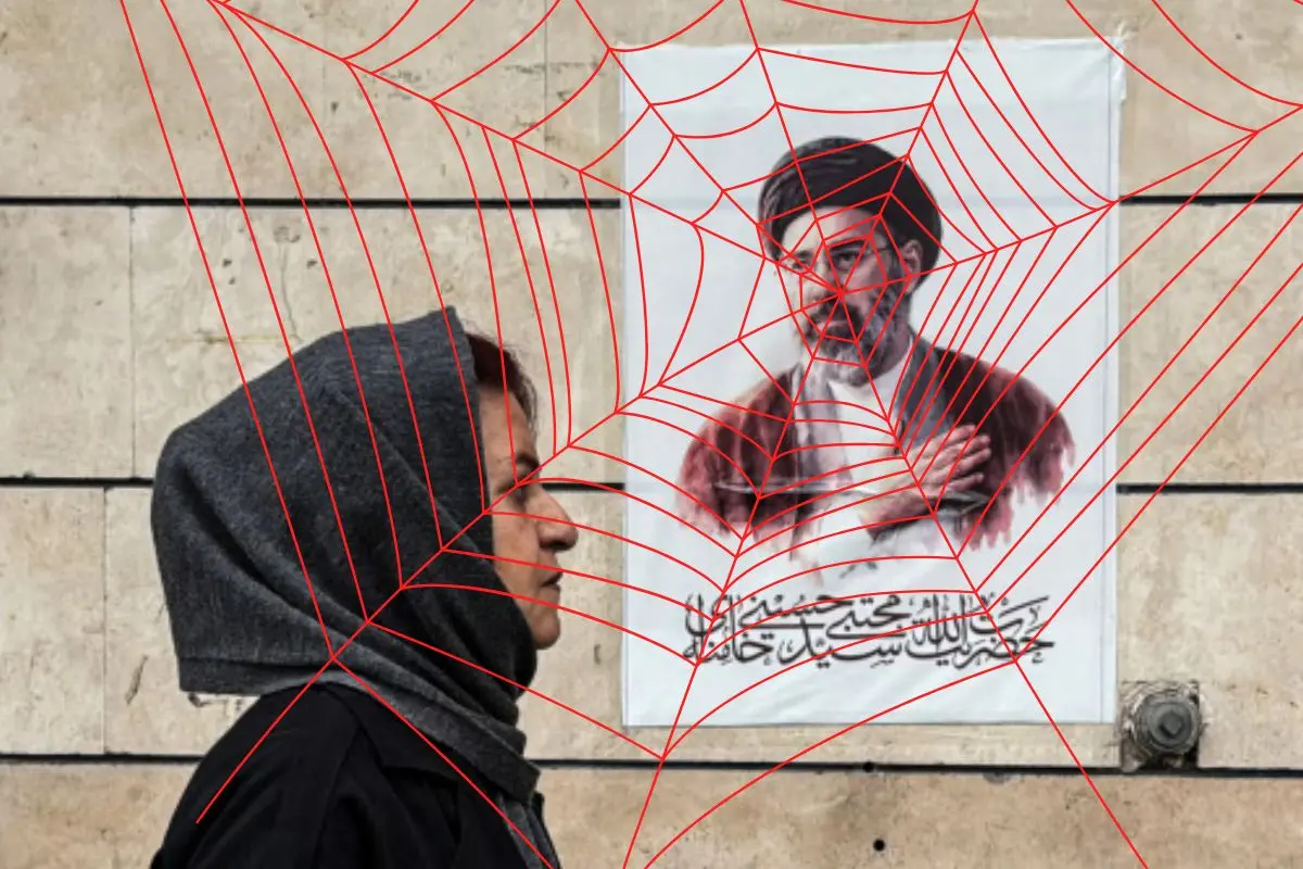 File photo | An Iranian woman walks past a poster featuring a portrait of Mojtaba Khamenei