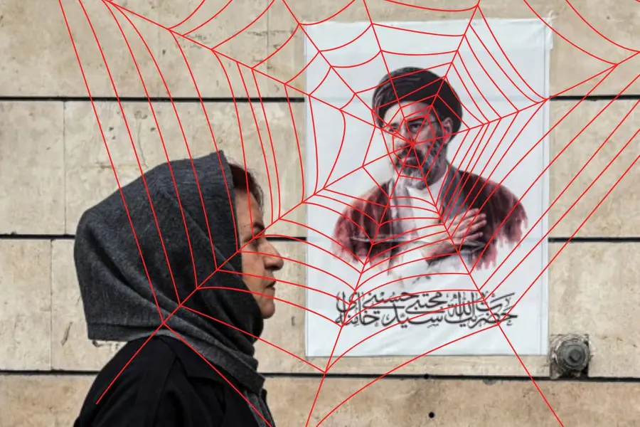 File photo | An Iranian woman walks past a poster featuring a portrait of Mojtaba Khamenei