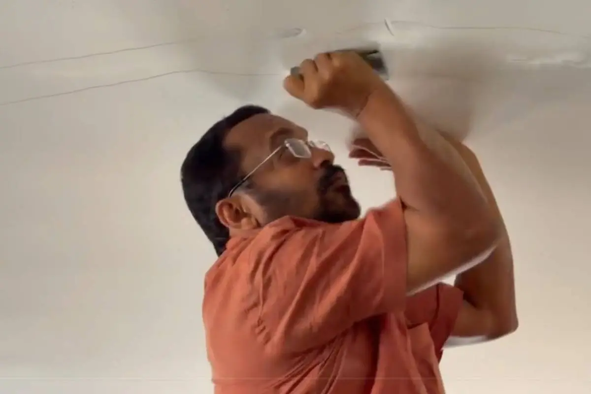 Revenue Minister K Rajan inspecting the cracks in the roof of a house at Mundkkai- Chooralmala township.