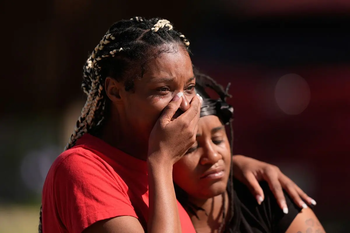 People comfort each other outside the scene of a mass shooting, Sunday, April 19, 2026, in Shreveport, La (Photo: AP)