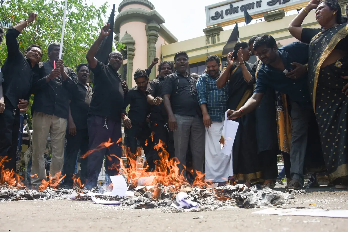 DMK supporters stage a protest by burning the xerox copy of the Constitution (131st Amendment) Bill 2026 and the proposed Delimitation Bill, alleged to reduce Tamil Nadu's parliamentary representation, at the party's headquarters in Chennai.| Photo: ANI