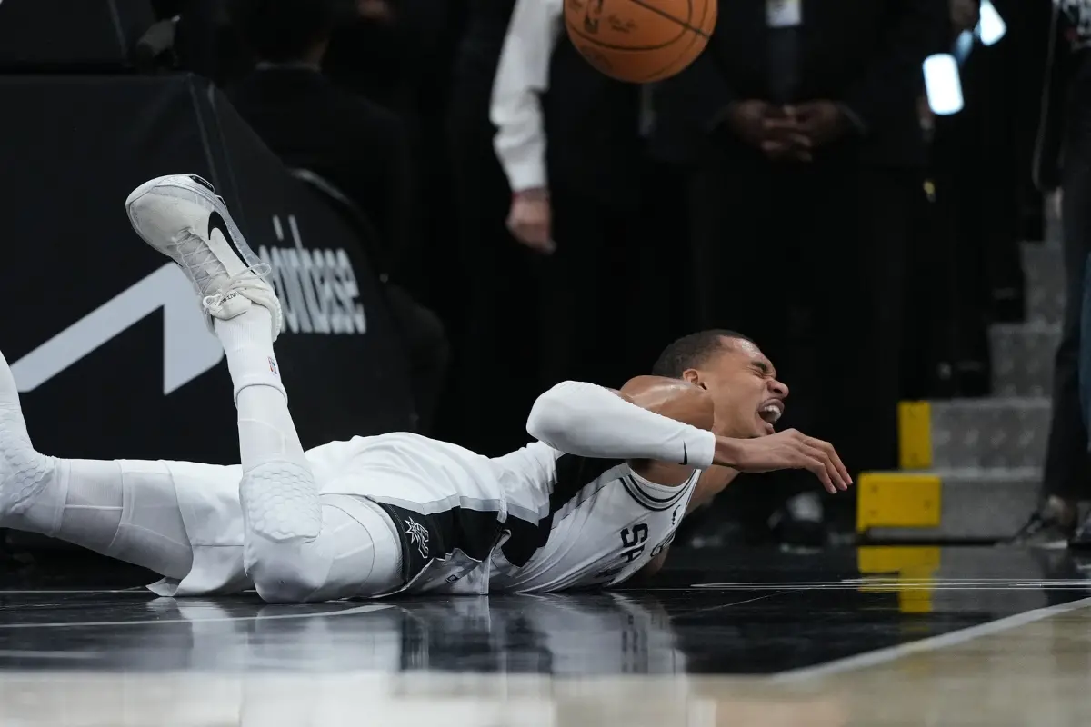 San Antonio Spurs forward Victor Wembanyama (1) takes a hard fall on the court during the first half in Game 2 of a first-round NBA playoffs basketball series against the Portland Trail Blazers | Photo: AP