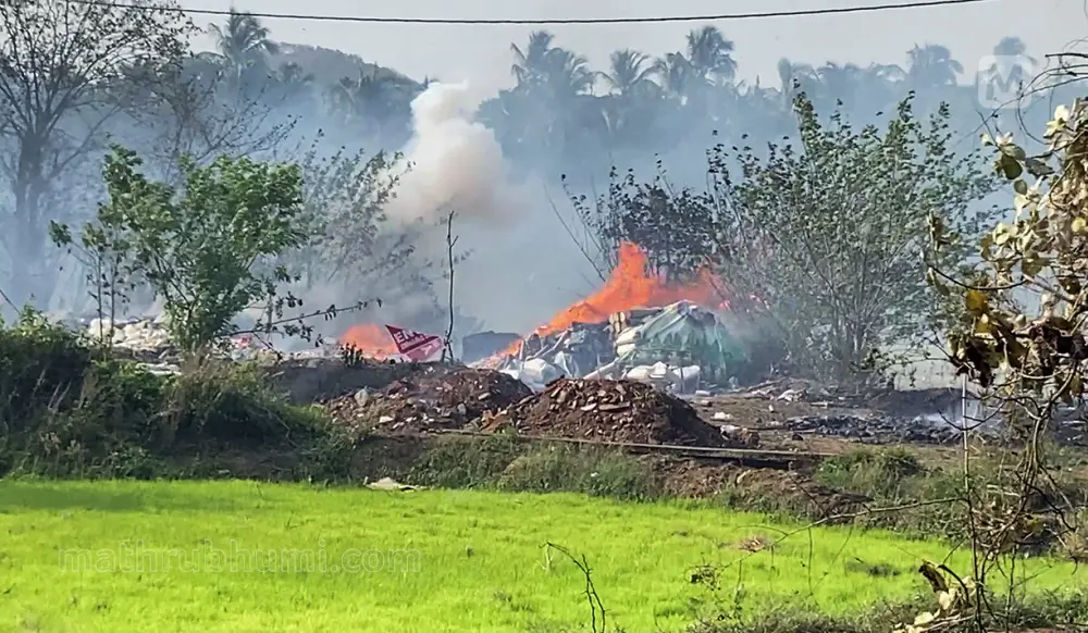 Dark smoke and flames billow out from the fireworks storage facility fire at Mundathikode, in Thrissur | ANI Video Grab