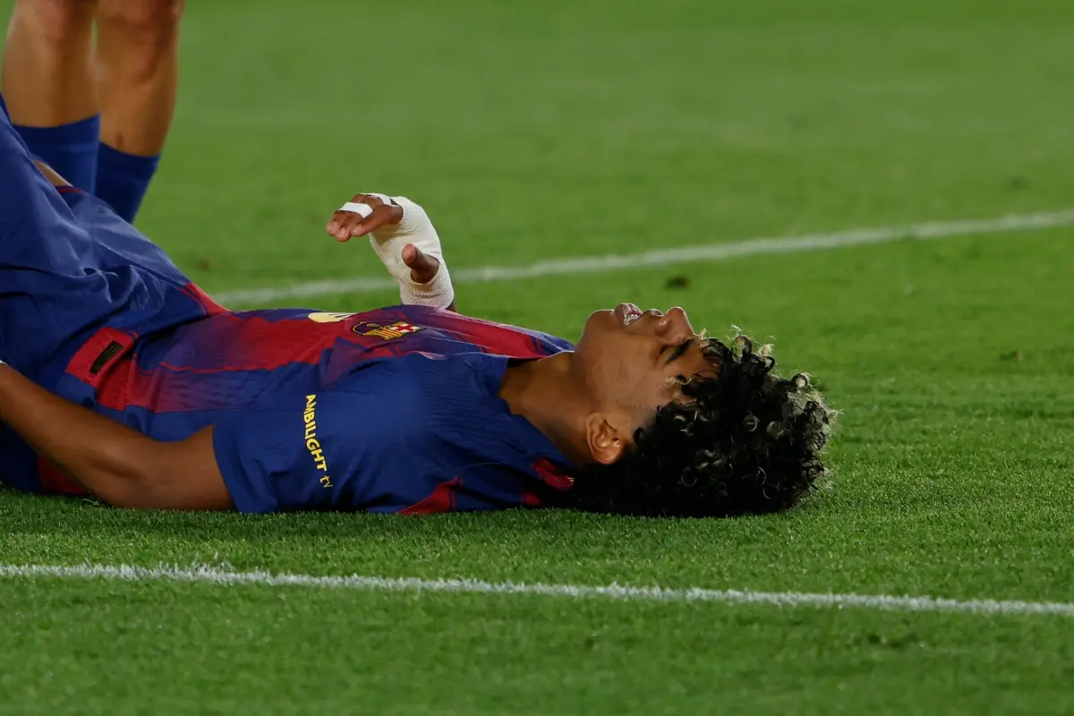 Barcelona's Lamine Yamal lies on the pitch injured during the Spanish La Liga football match between Barcelona and Celta Vigo in Barcelona, Spain | Photo: AP