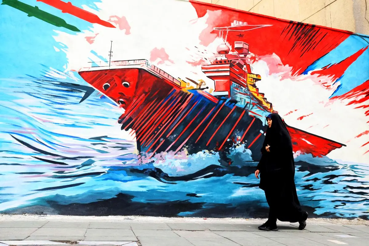 A woman walks past an anti-US and anti-Israel mural, in Tehran on April 21 2026. Photograph: Atta Kenare/AFP