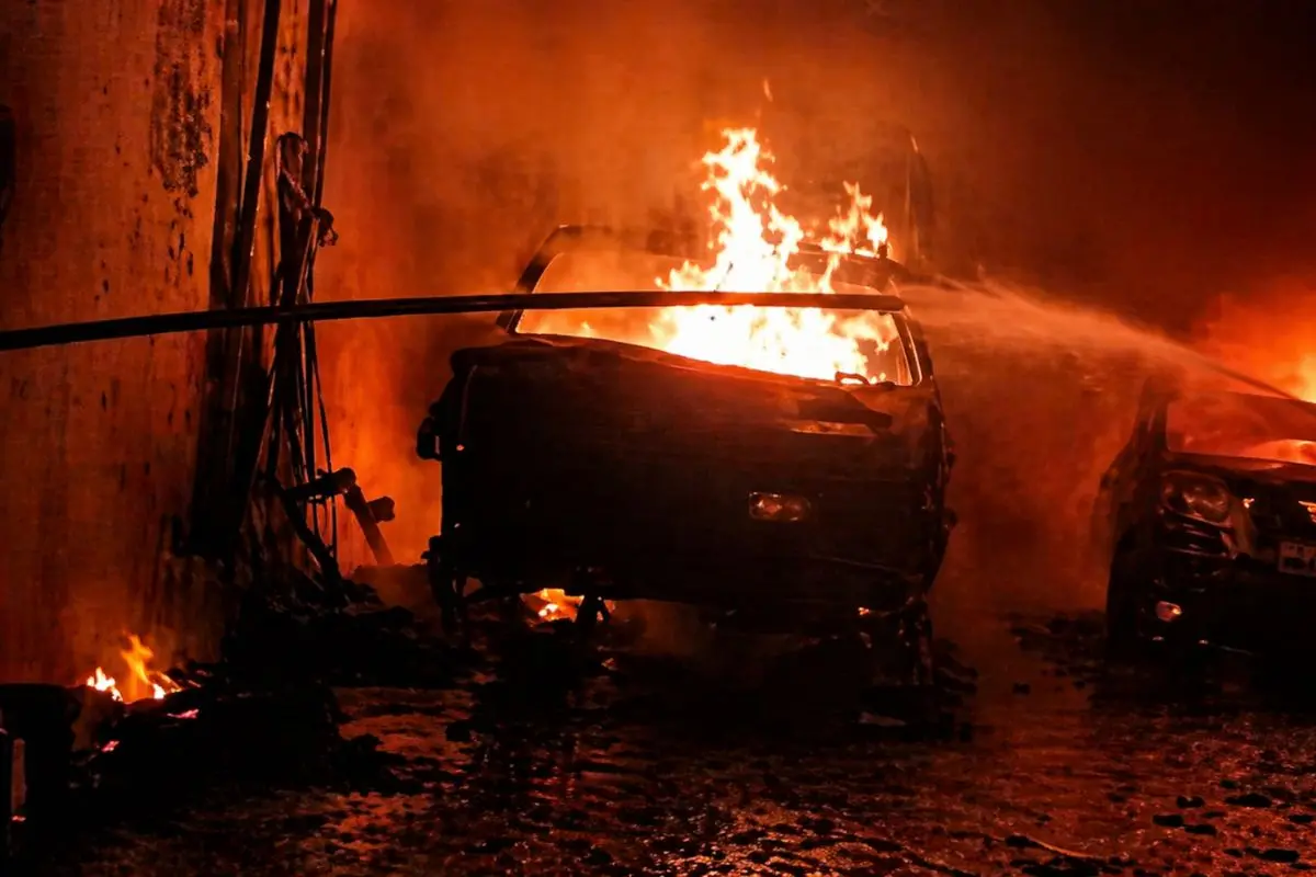 Flames engulfing vehicles inside a garage at Eidgah Chowk in Kanpur. (Screengrab: ANI video)
