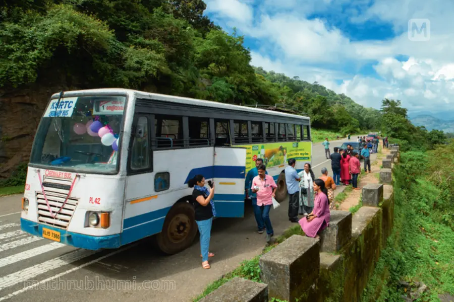A KSRTC bus parked at a scenic tourist location in Kerala, symbolizing the success of the Budget Tourism Cell's holiday excursion program