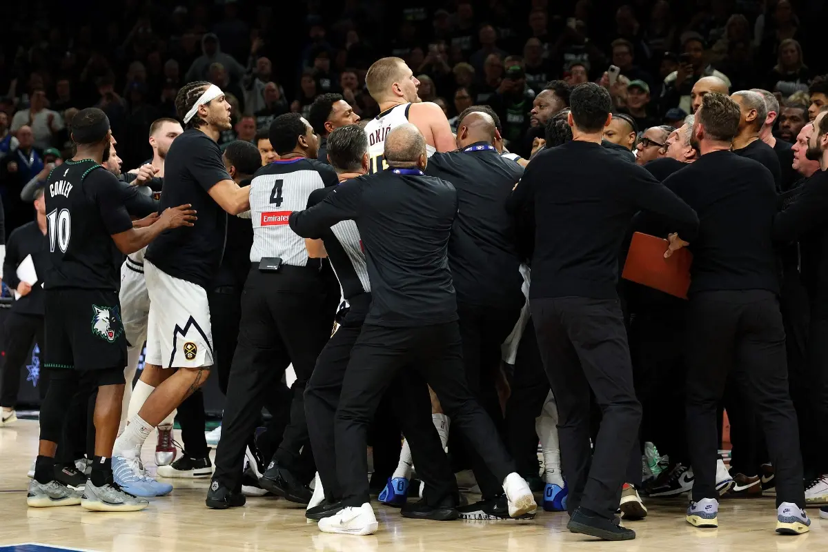 Members of the Denver Nuggets and Minnesota Timberwolves get into a scrum in the fourth quarter of Game Four of the First Round of the 2026 NBA Western Conference Playoffs at Target Center on April 25, 2026 in Minneapolis, Minnesota. Nikola Jokic #15 of the Denver Nuggets and Julius Randle #30 of the Minnesota Timberwolves were ejected from the game. | Photo: Getty Images via AFP