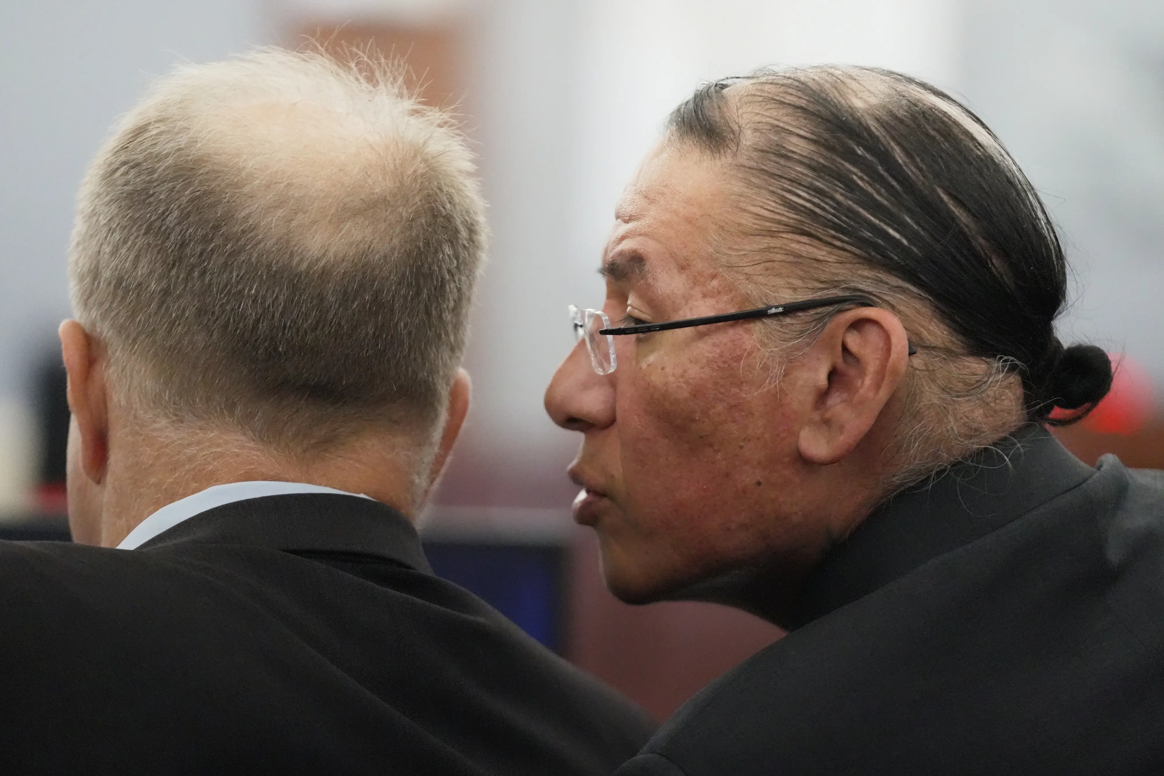 Nathan Chasing Horse, right, talks to his attorney Craig Mueller during his trial | AP