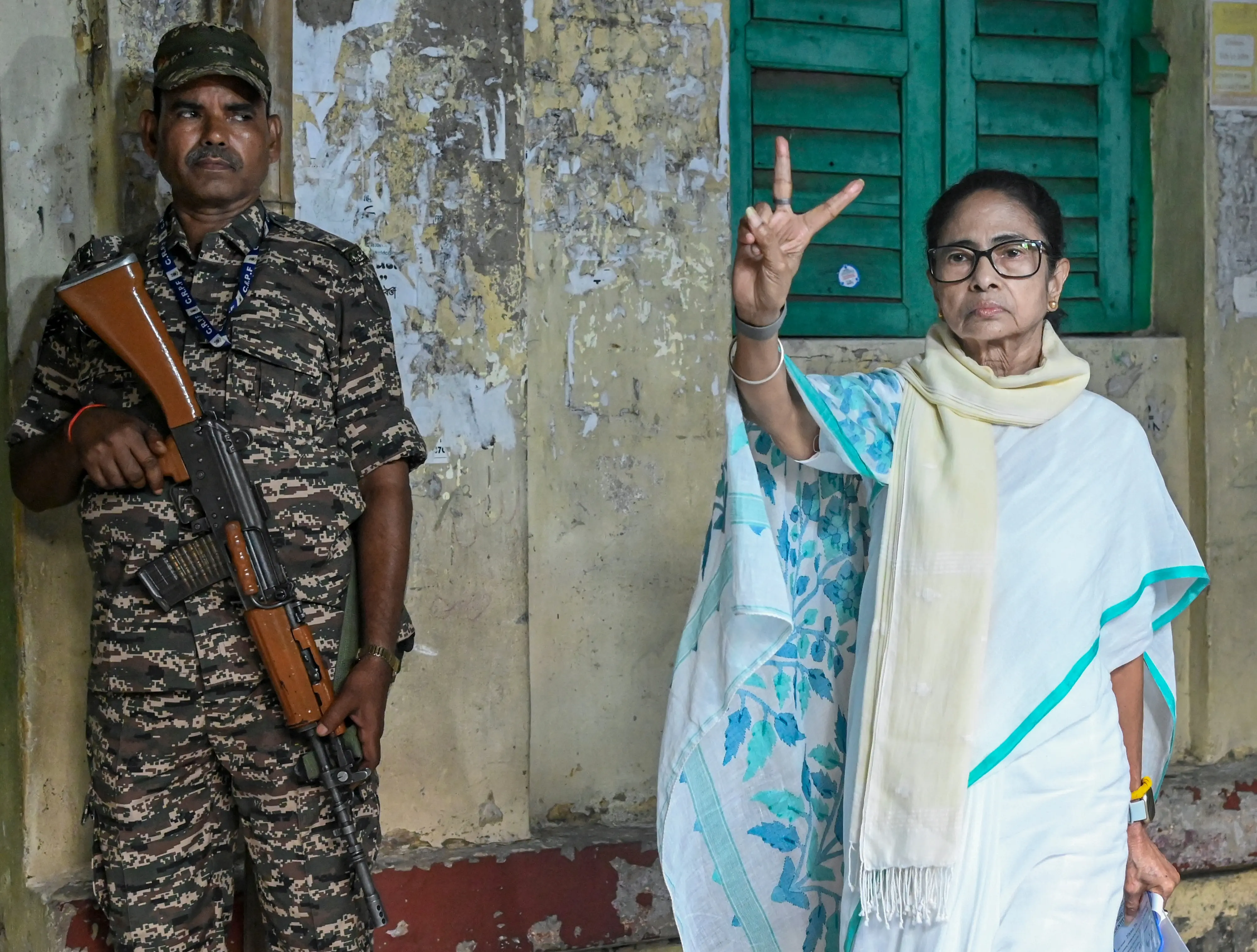 West Bengal Chief Minister and Trinamool Congress (TMC) candidate from Bhabanipur constituency, Mamata Banerjee, shows her ink-marked finger after casting a vote