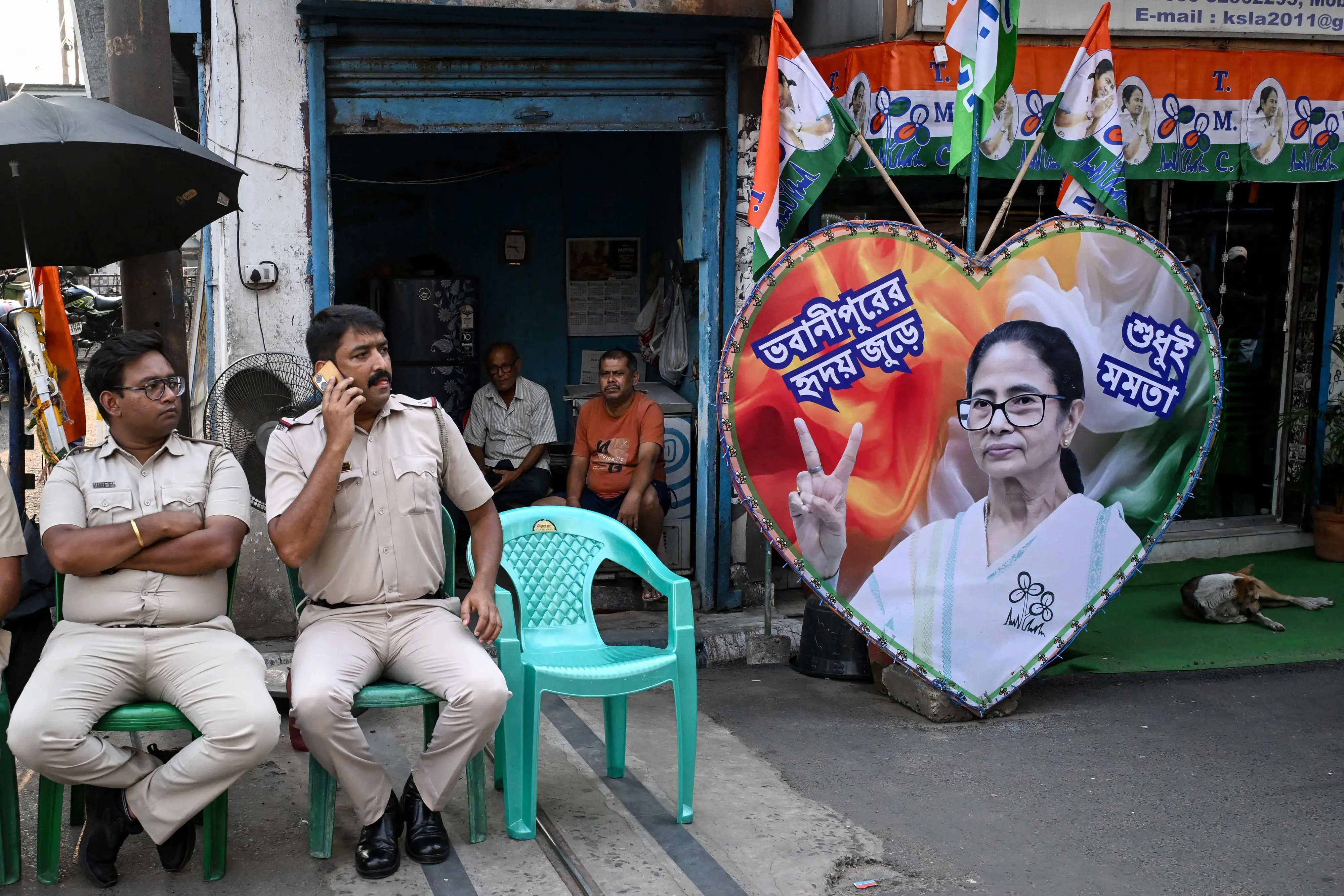 Police personnel guard the road leading towards the residence of All India Trinamool Congress (TMC) party chairperson Mamata Banerjee | AFP