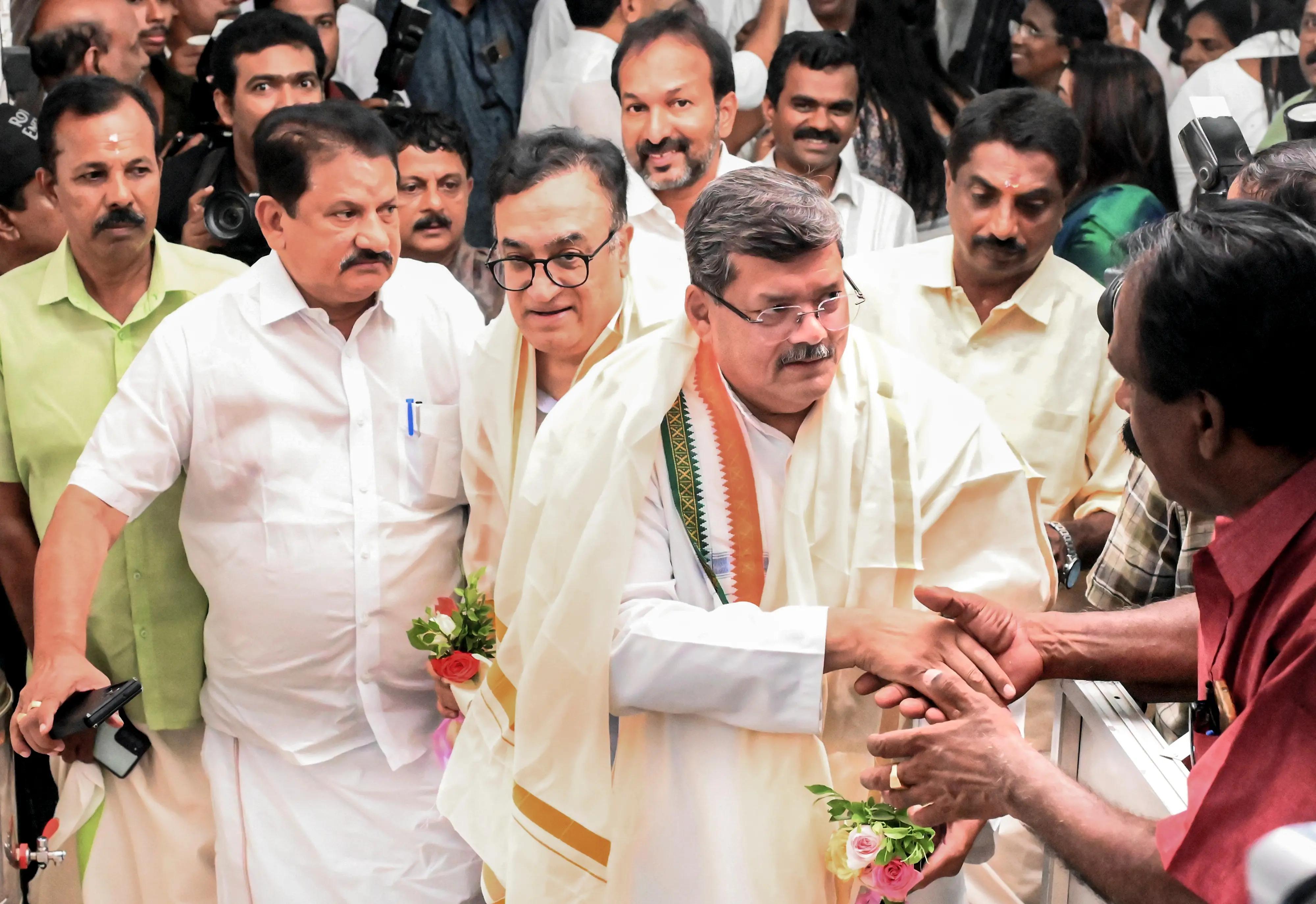 AICC observers Ajay Maken and Mukul Wasnik being received by Congress workers upon their arrival for the meeting of the Congress Legislature Party (CLP) to decide on the chief ministerial candidate in Kerala, at the party headquarters in Thiruvananthapuram on Thursday, May 7, 2026 | Photo: PTI