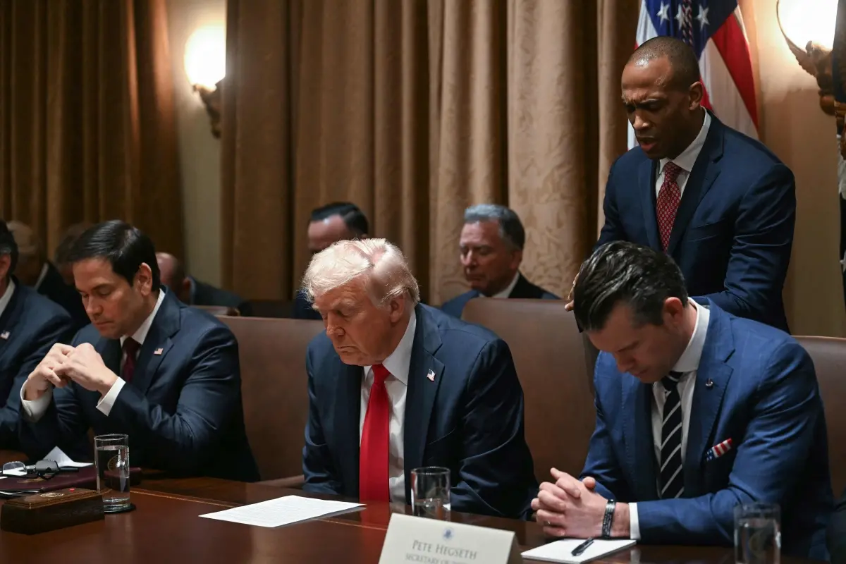 File phto | US President Donald Trump bows his head in prayer alongside Secretary of State Marco Rubio, Secretary of Defense Pete Hegseth