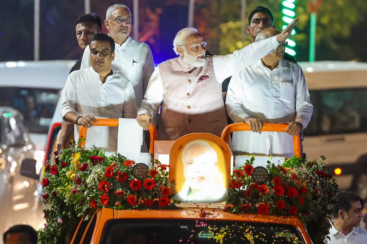 Prime Minister Narendra Modi waves to the crowd during a roadshow, in Vadodara.| Photo: ANI