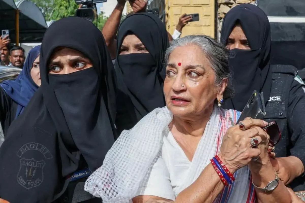 Pakistani feminist icon and classical dancer Sheema Kirmani being escorted by hijab-clad women police personnel during a brief detention near Karachi Press Club amid an Aurat March permit protest. (Screengrab: X video)