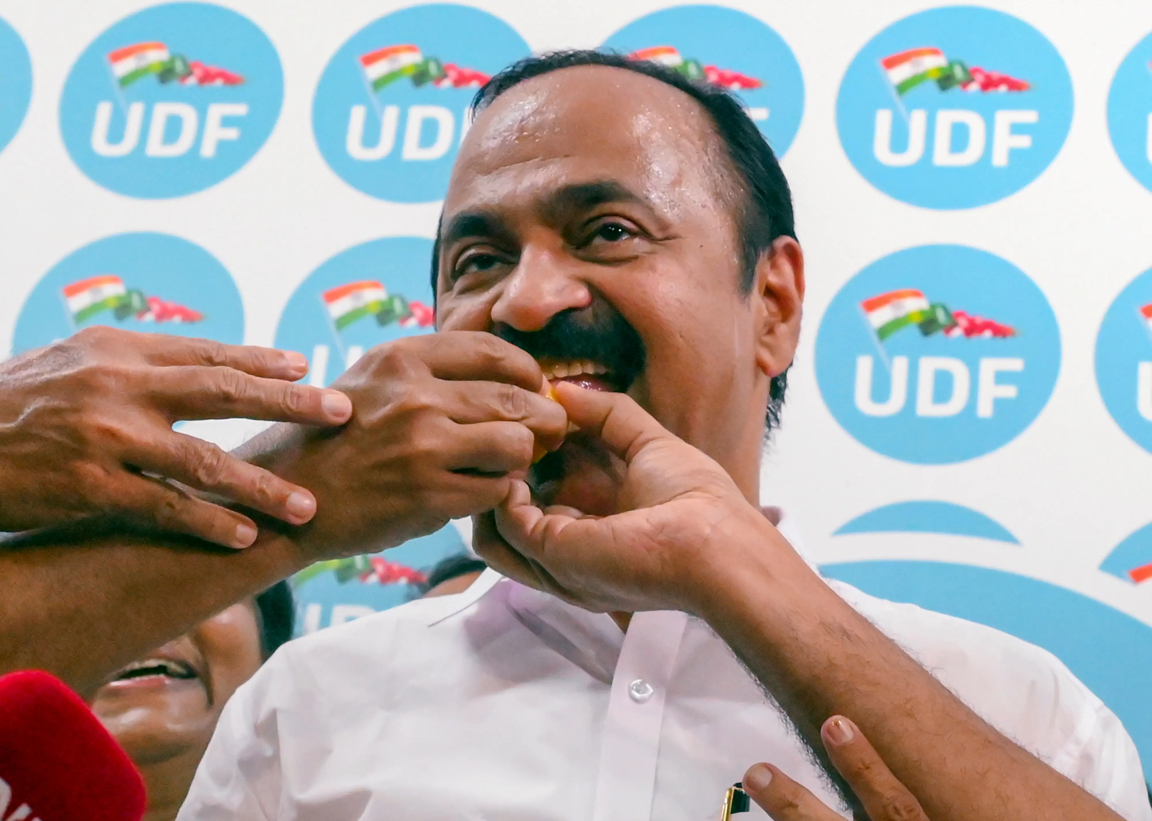 Congress leader VD Satheesan being offered sweets by party workers | PTI