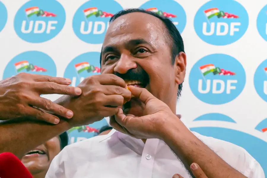 Congress leader VD Satheesan being offered sweets by party workers