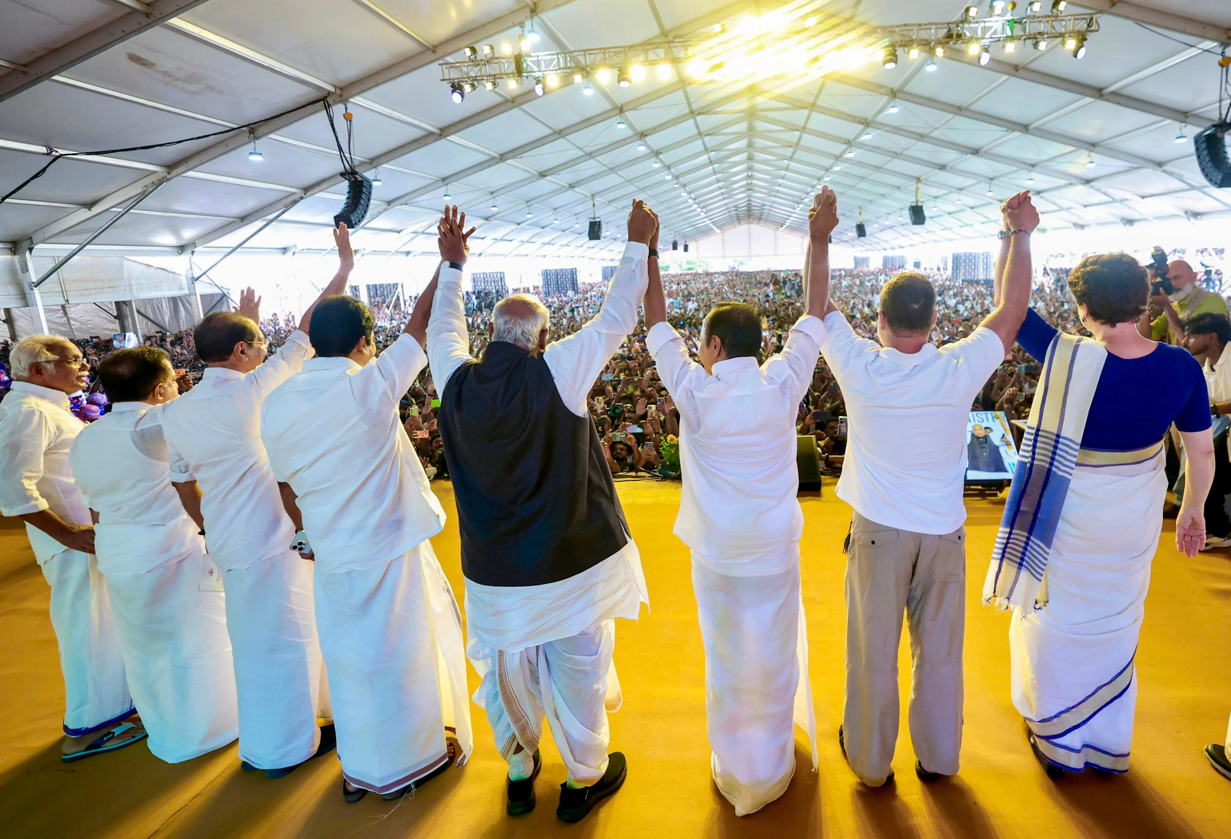 Congress leaders join hands during the swearing-in ceremony of the Kerala government